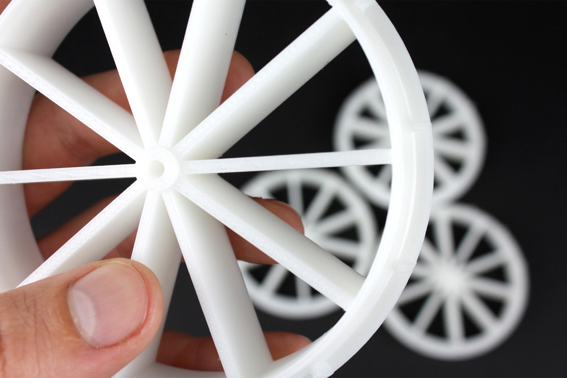 White 3D printed spoked wheels.