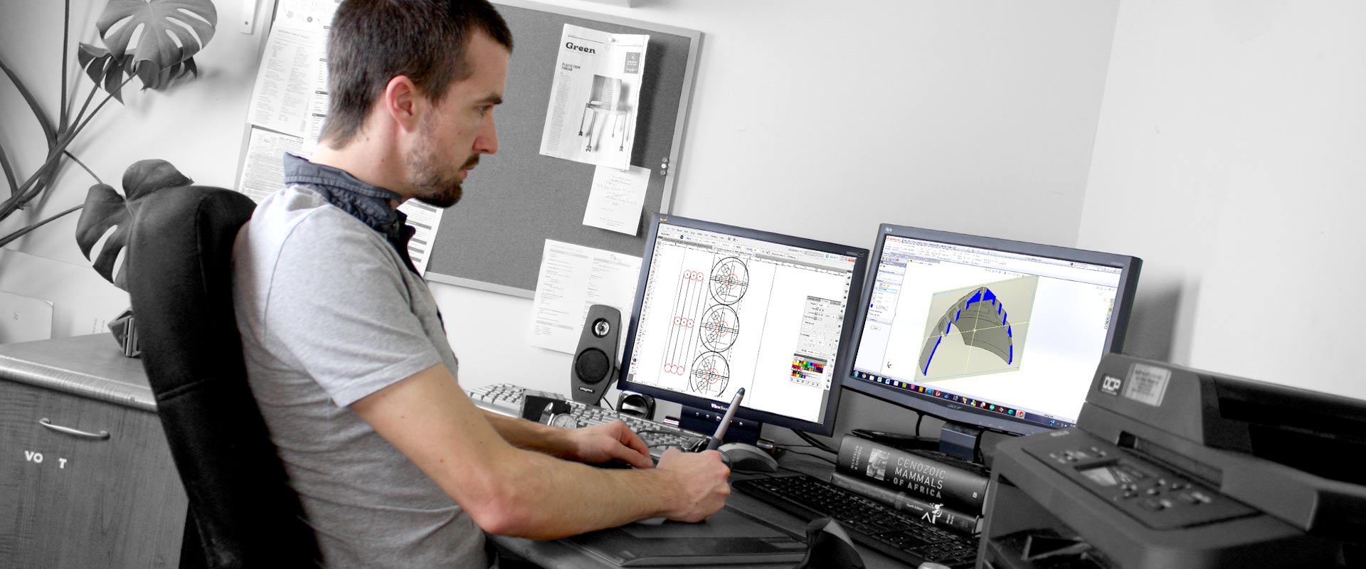 The owner working on his computer, designing something in CAD.