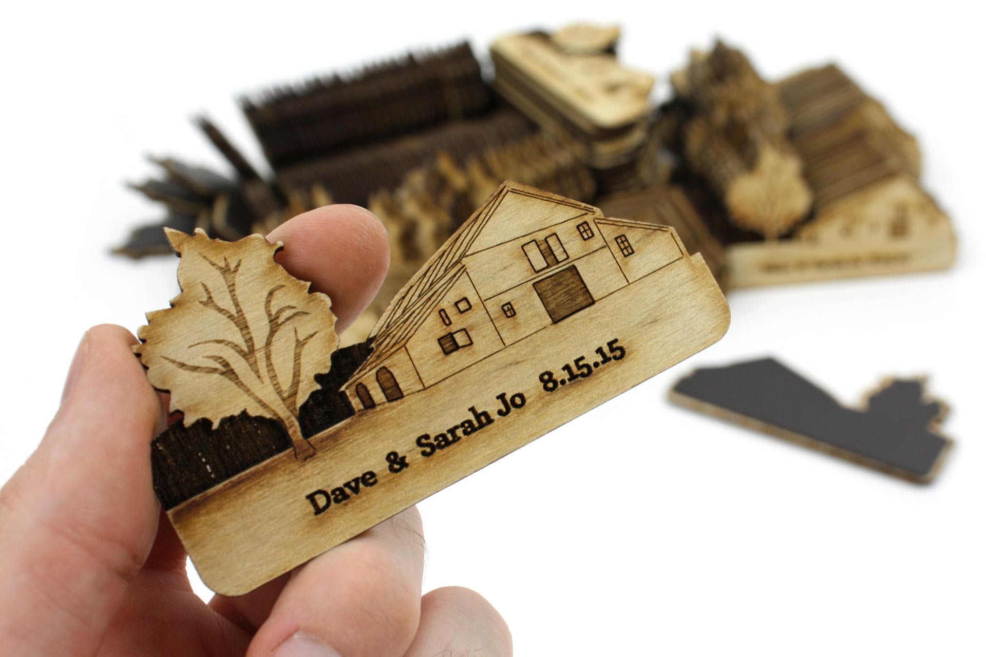 Laser cut wood and magnetic material of a barn with a tree and date.