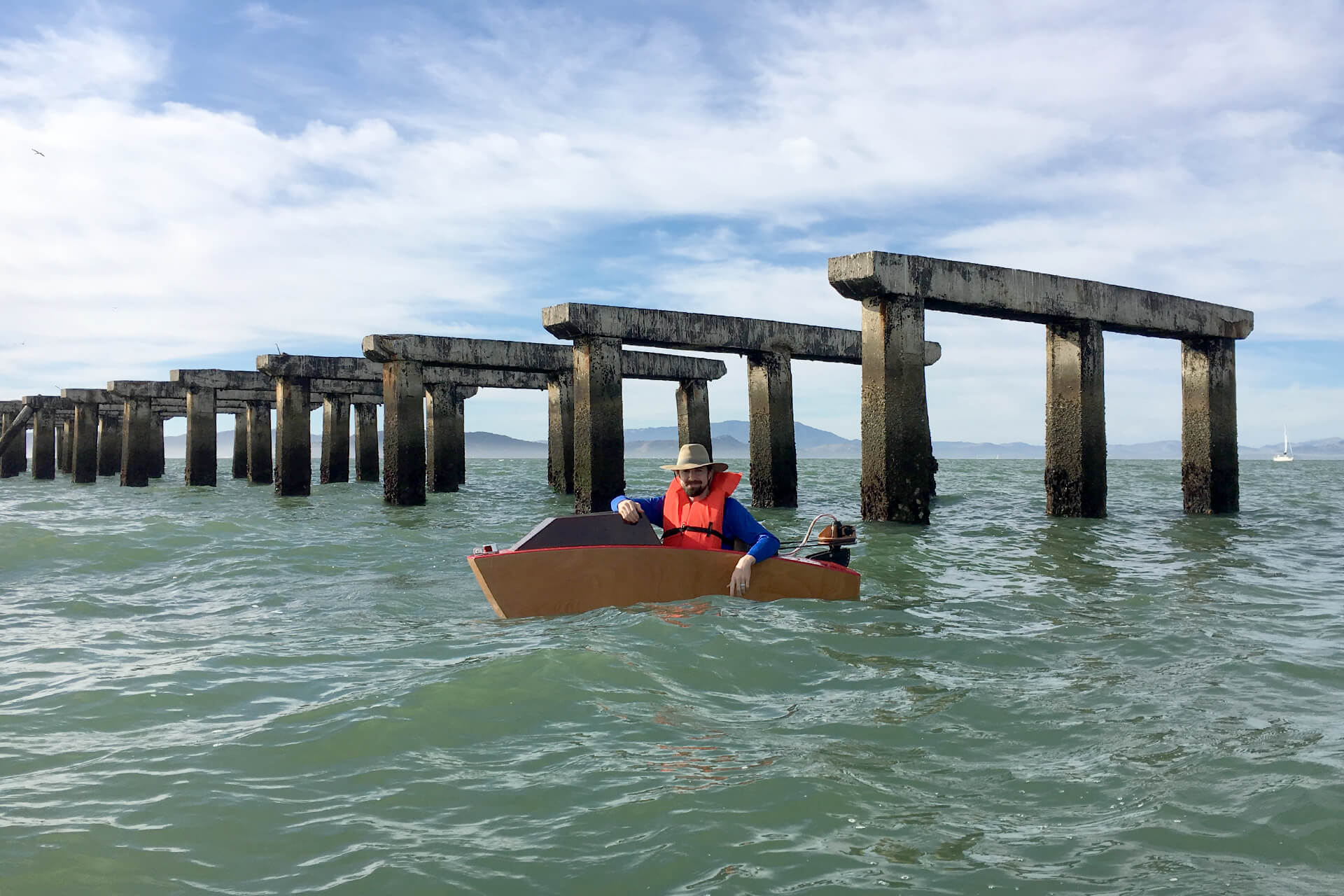 A mini boat in front of the Berkeley pier ruins.