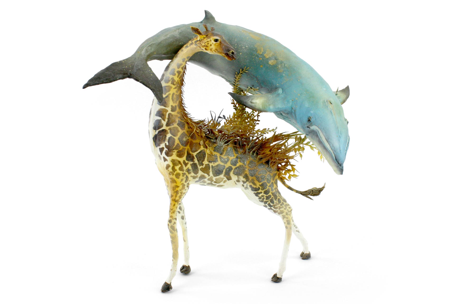 A sculpture of a giraffe and whale.